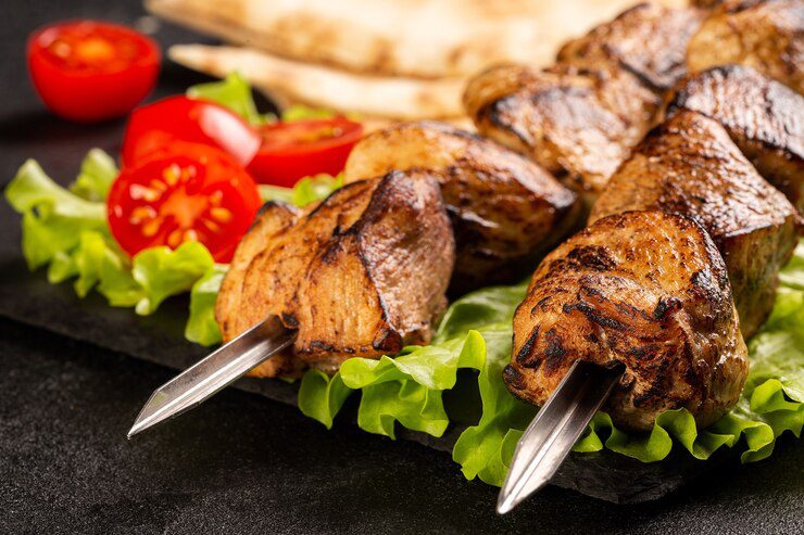two_portions_of_shish_kebab_on_a_stone_plate_with_salad_sliced_pita-6.jpg